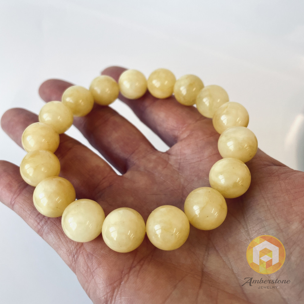 سوار بوهو شيك عنبر وردي-برتقالي: مجوهرات مصنوعة يدوياً فريدة من نوعها مع العنبر الطبيعي